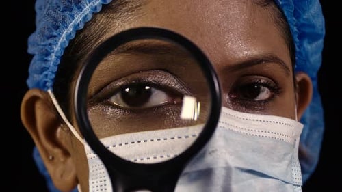 Doctor Examines Patient with Magnifying Glass Close Up