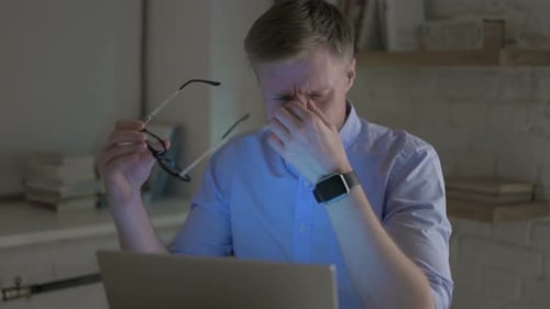 Man Experiencing Eye Strain at Computer