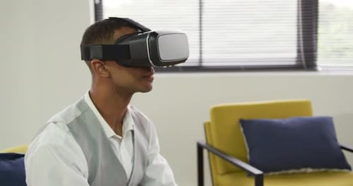 Young Man Using VR Headset Indoors