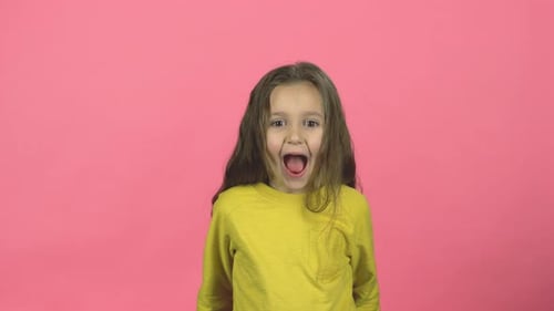 Cute Baby Screaming with Smile on Pink Background in the Studio