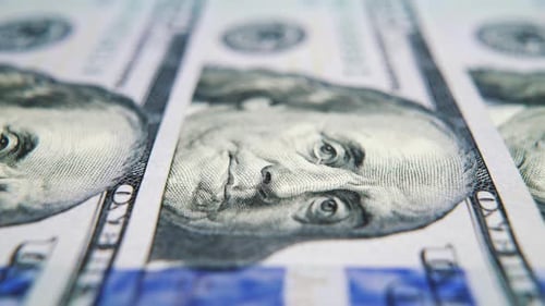 Macro of US Hundred Dollar Bills Lying in Row