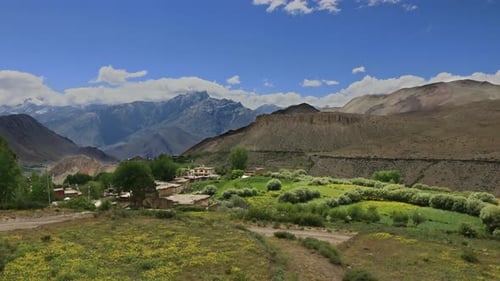 Timelapse Clouds Swirl Over a Green Mountain Valley