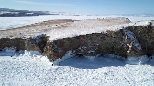 Aerial View of an Island in Frozen Lake Baikal with Many People Walking Around