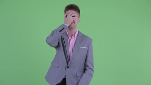 Disappointed Young Man Using a Phone