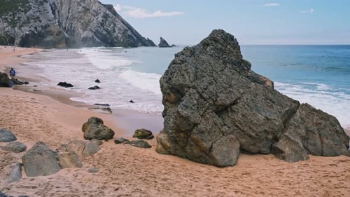 Praia Da Adraga Beach. White Atlantic Ocean Waves Rolling Towards Sandy Beach. Sintra, Portugal
