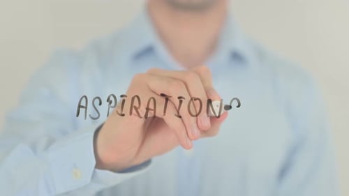 Man Writes Aspirations on Clear Glass Surface