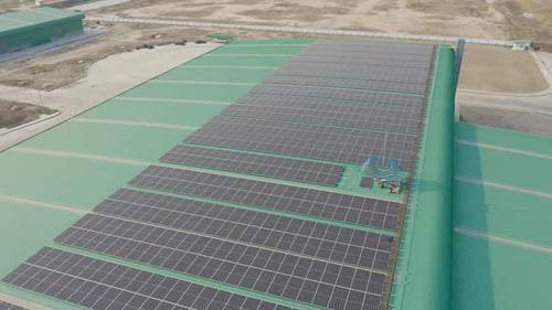 Aerial top view of solar panels or solar cells on the rooftop of factory industry building.