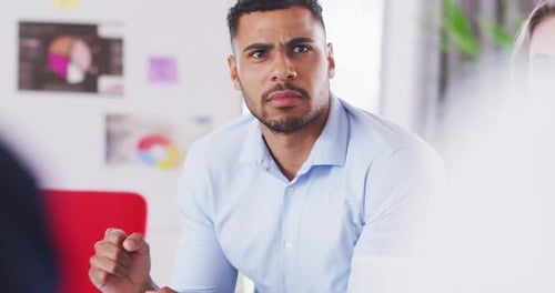 Professional businessman talking to his colleagues while sitting in modern office in slow motion