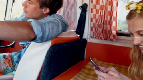 Young Adults Driving Vintage Van on Road Trip