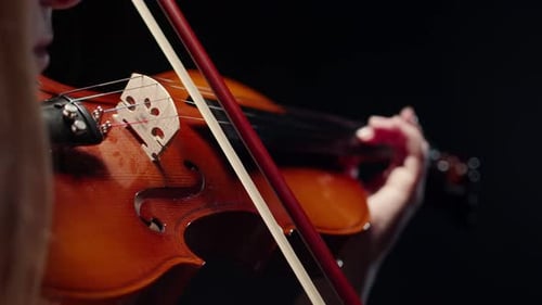 Woman Playing Violin Close Up on Black
