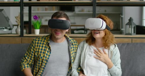 Couple Is Impressed with Virtual Reality Video, Sitting on Sofa, Close Up