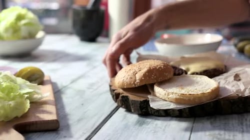 Preparing Burger with Fresh Toppings and Sauce