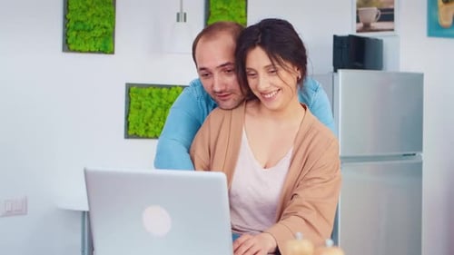 Loving Couple Using Laptop in Modern Home