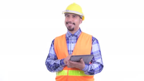 Happy Bearded Persian Man Construction Worker Thinking While Using Digital Tablet