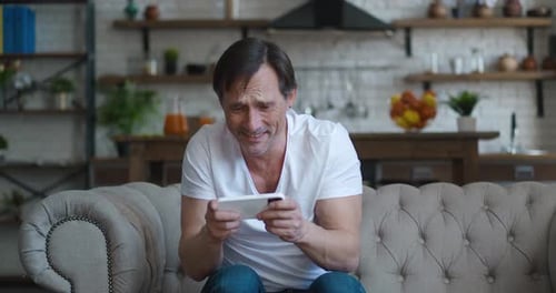 Excited Man Playing Video Games on his Phone