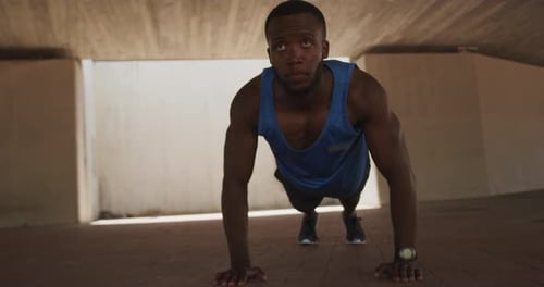 Man Doing Pushups in Urban Setting