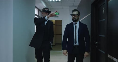 Businessmen Using VR Glasses in Office Corridor