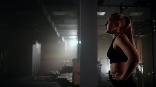 Young Woman Resting After Her Workout and Looking Down