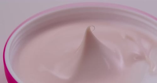 Close-Up Pink Face Cream Rotating in Jar