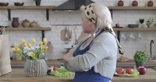 Mature Woman Poses in her Cheerful Kitchen
