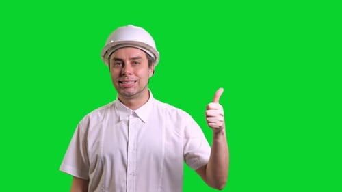 Young Male Engineer Standing Smiling and Doing Thumbs Up on Green Screen Background