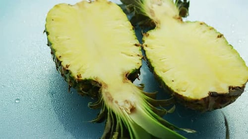 Fresh Pineapple Cut in Half on Wet Surface