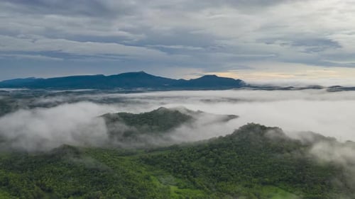 Flying through the clouds above the mountain peak.
