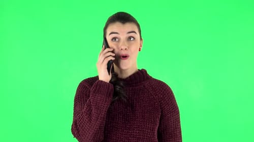 Portrait of Smiling Girl Talking for Mobile Phone and Rejoice. Green Screen