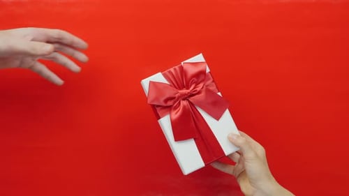 Giving a Gift on Red Background