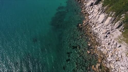 Aerial Shot of Mountain Cliff and Blue Sea Water