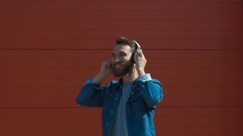 Man Dancing to Music with Headphones Outdoors