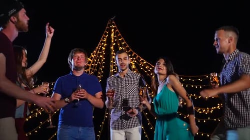 Friends Dancing at Evening Birthday Celebration