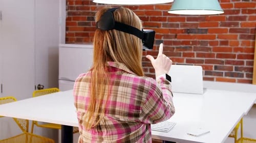 Woman Uses VR Headset at Modern Table