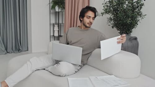 Junger Geschäftsmann arbeitet zu Hause