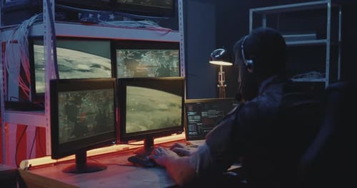 Man Working at Computer Station at Night