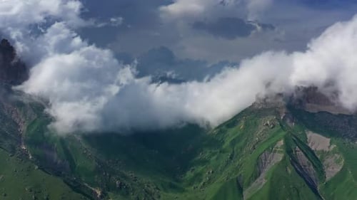 Aerial View of Lush Mountains with Clouds