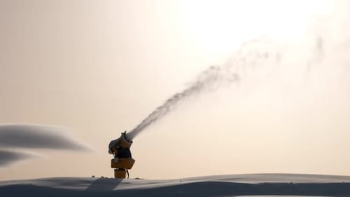 Snow Cannon Blowing Artificial Snow in Winter Landscape