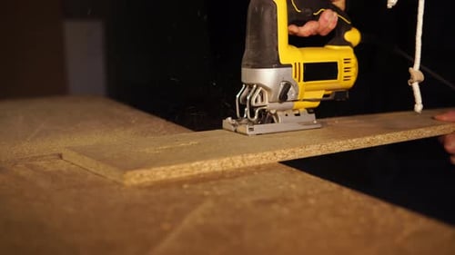 Carpenter Works with Electric Saw