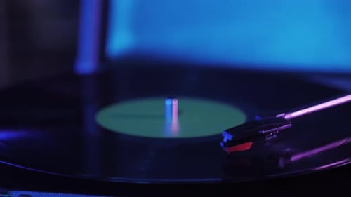 Vinyl Record Spins on Turntable in Dark Room
