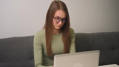 Young Adult Working on Laptop at Home