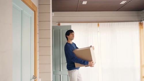 Happy Couple Bringing Boxes with Personal Things After Relocation To New House