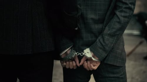 The Police Take the Handcuffed Prisoner To the Prison. Detention of a Suspect. Back View