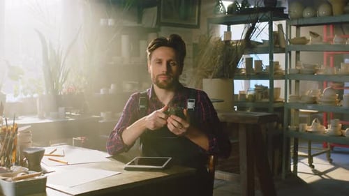 Man at Desk Drinking Mug in Studio