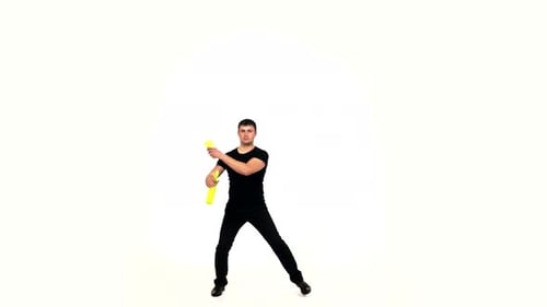 Man Juggling Yellow Clubs on White Background