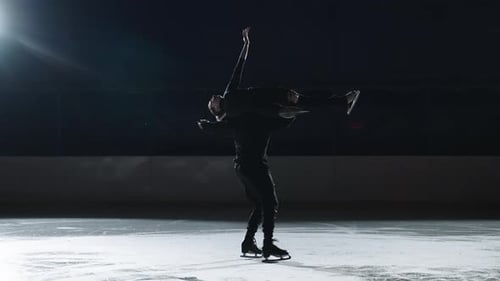 Pairs Figure Skating Team Performs Lift on Ice Rink