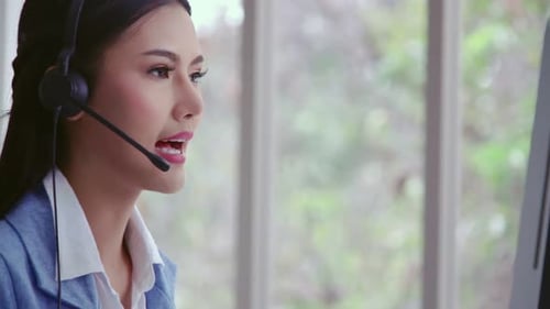 Customer Support Agent or Call Center with Headset Talking to Customer on Phone