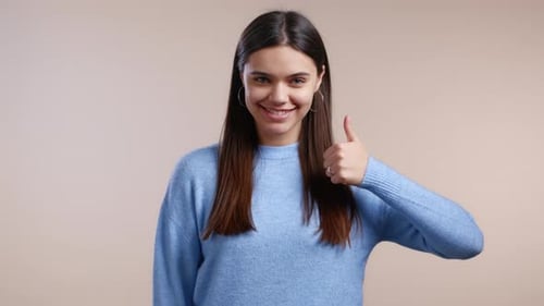 Happy Woman Gives Thumbs Up Gesture