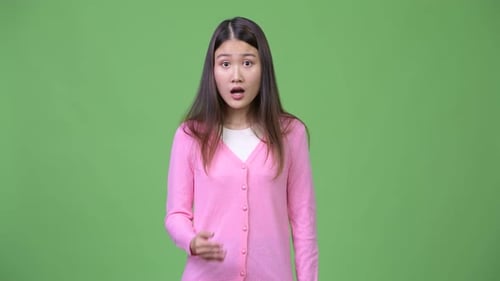 Young Woman Reacts in Surprise Against Green Screen