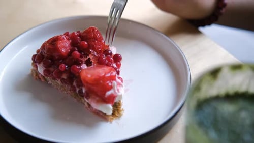Fork Takes Bite of Berry Tart Dessert
