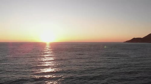 Sun touches water surface, Sunset